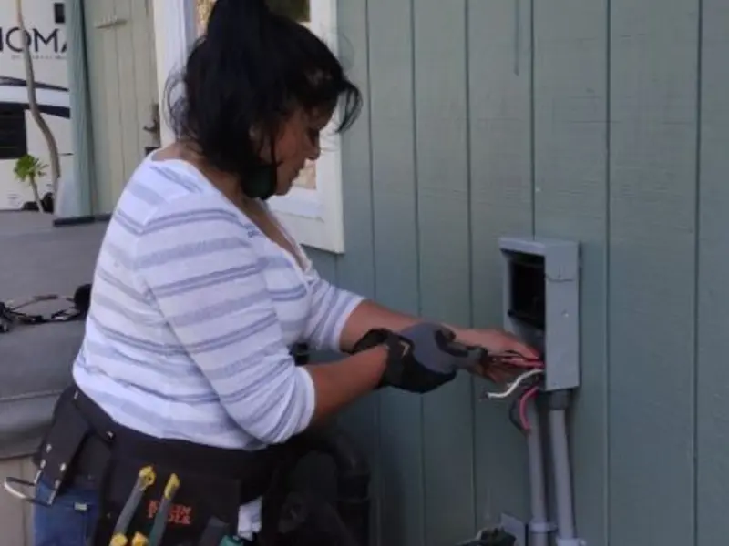 Licensed electrician wiring an exterior subpanel in The Pinery